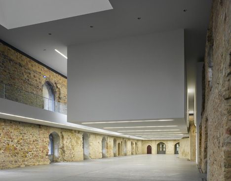 The roof and interior redesign have been delicately put on top of the existing stone walls.
