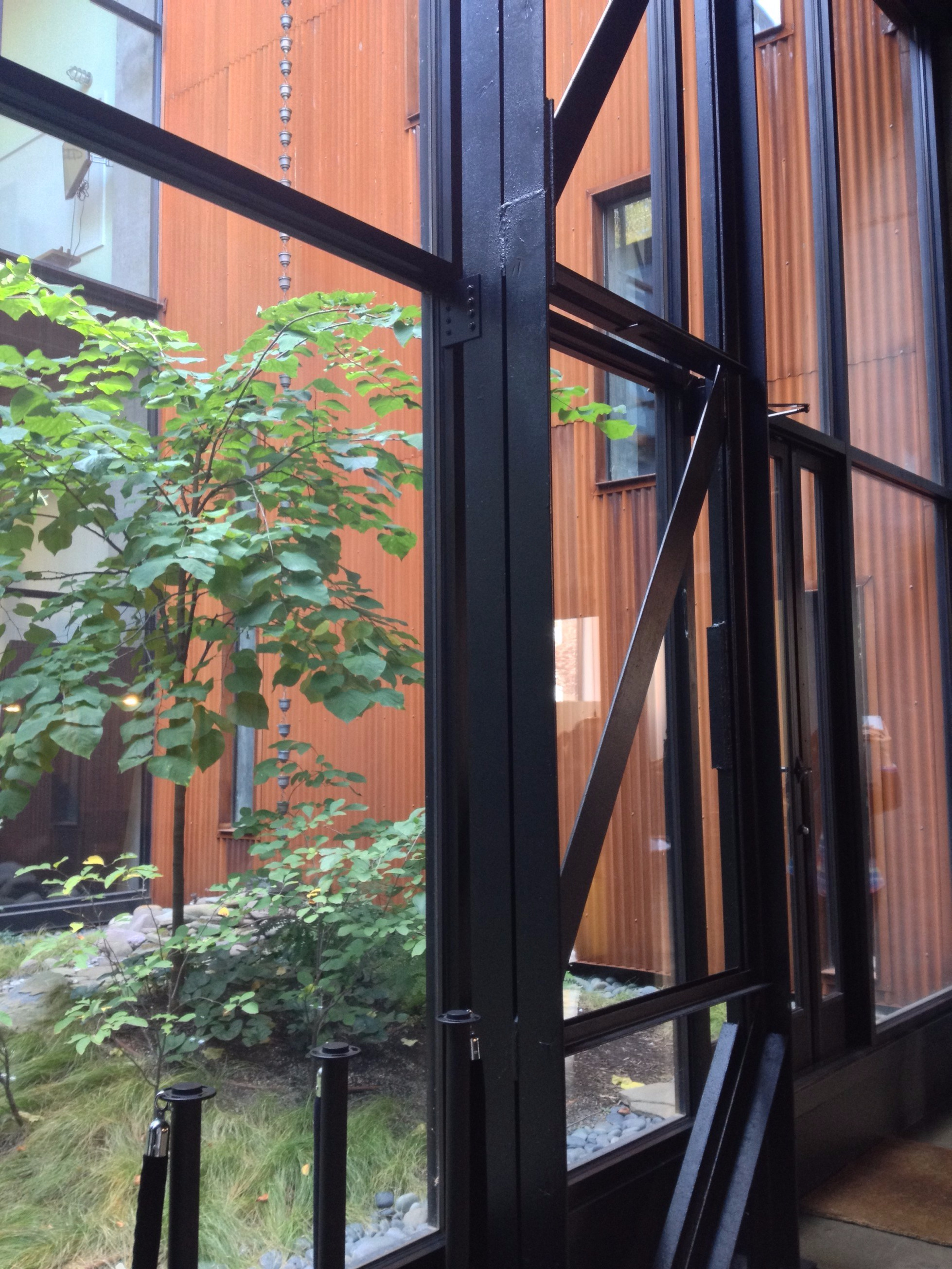 The discarded slab steel trusses are reused to support the new glass façade.